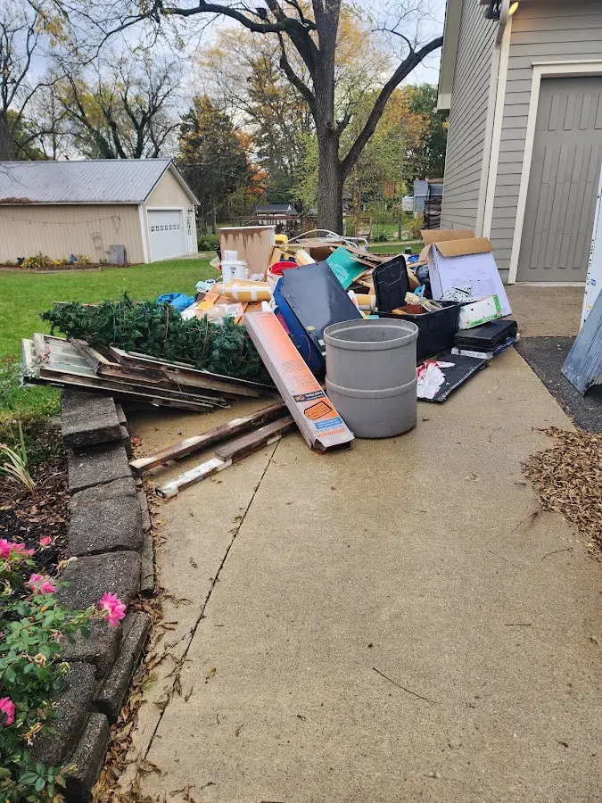 Dumpster being loaded with debris for Estate Cleanout Dumpster Rental in Sun City
